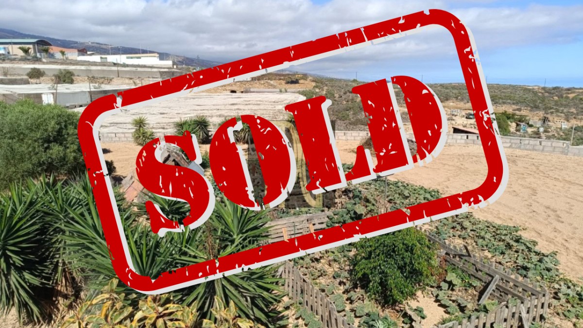 SOLD Large red 'SOLD' stamp across a rural property view, indicating the lot has sold