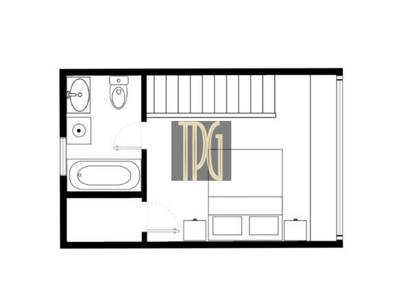 Floor plan of a small apartment: bathroom on the left with tub, sink, and toilet; staircase in the center; living/sleeping area on the right with a sofa and storage.