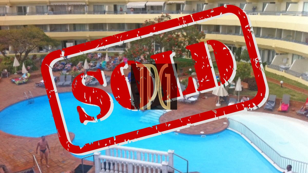 SOLD1861 Overhead view of a hotel pool with a large red 'SOLD' stamp across it.