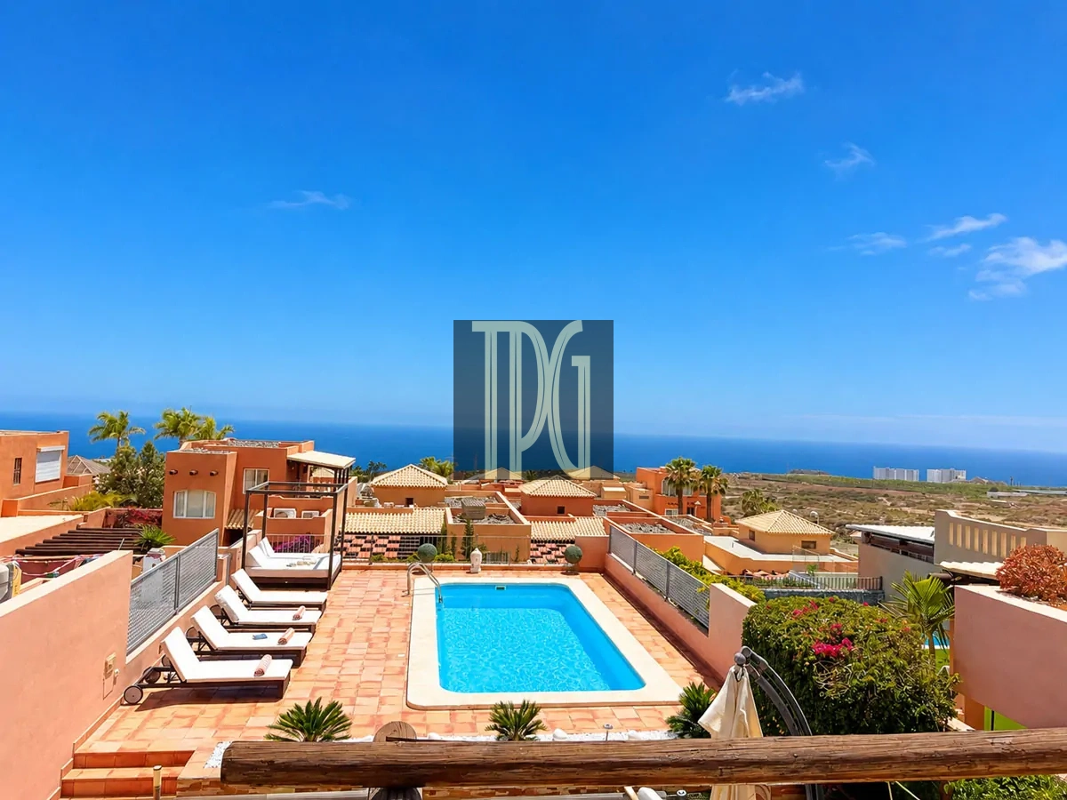 File 00007jpg Terrace swimming pool with sun loungers and orange villas, overlooking the ocean on a sunny day.