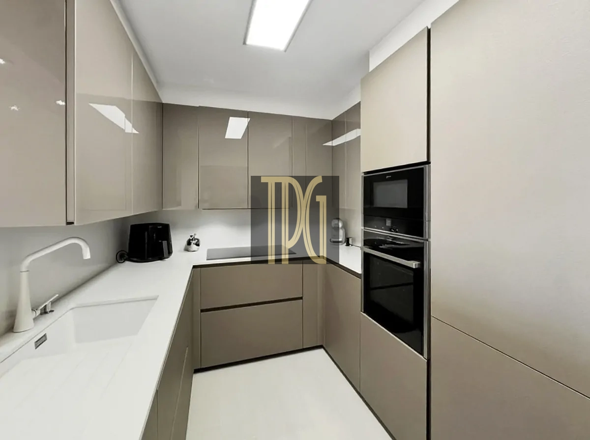 File 00030jpg U-shaped modern kitchen with beige glossy cabinets, white countertops, and built-in oven/microwave on the right.