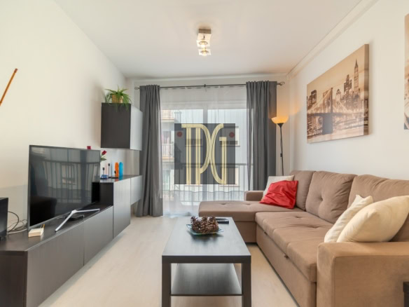 Cozy modern living room with a brown sectional sofa, coffee table, and flat-screen TV facing the seating area.
